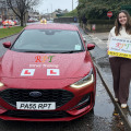 New driver holding pass certificate after passing driving test in Halifax